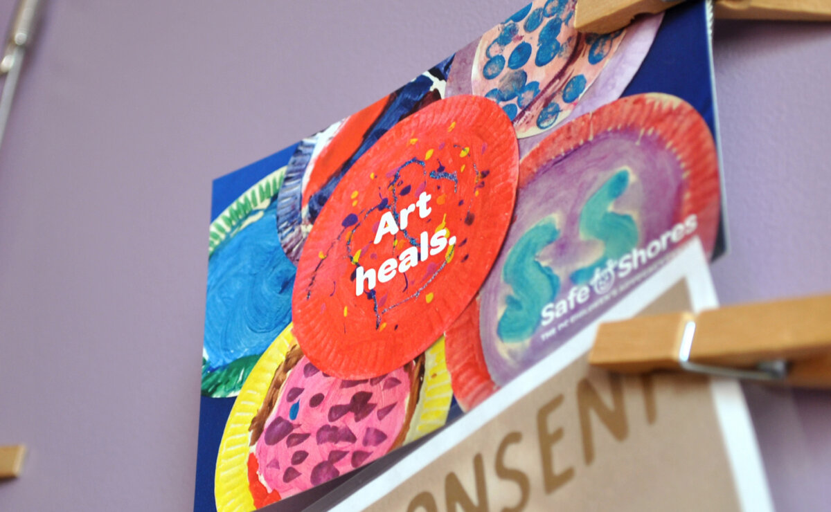 Child's art that reads "art heals" on the wall at Safe Shores
