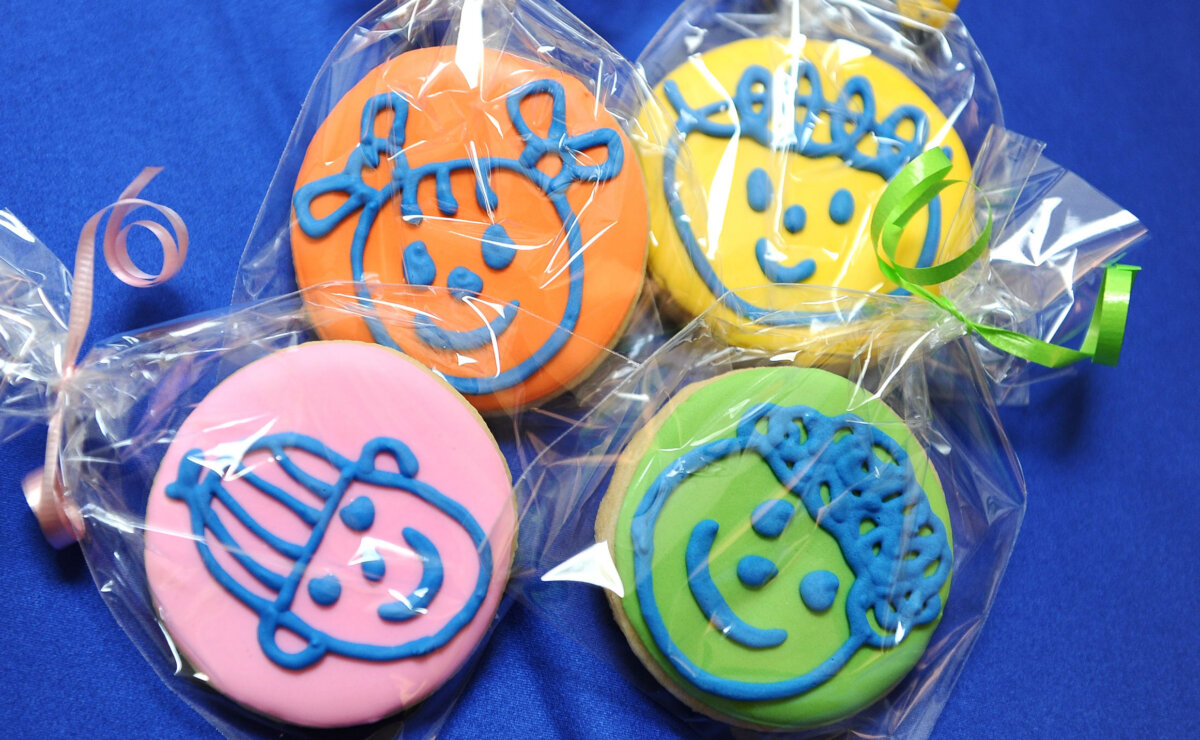 Four cookies with the Safe Shores logo characters in icing